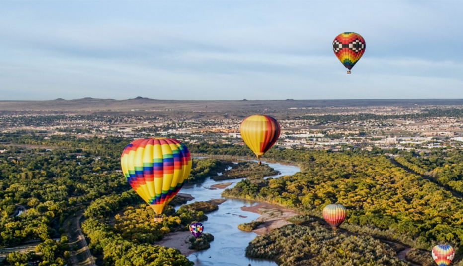 New Mexico Work and Save Hot air balloons flying over countryside